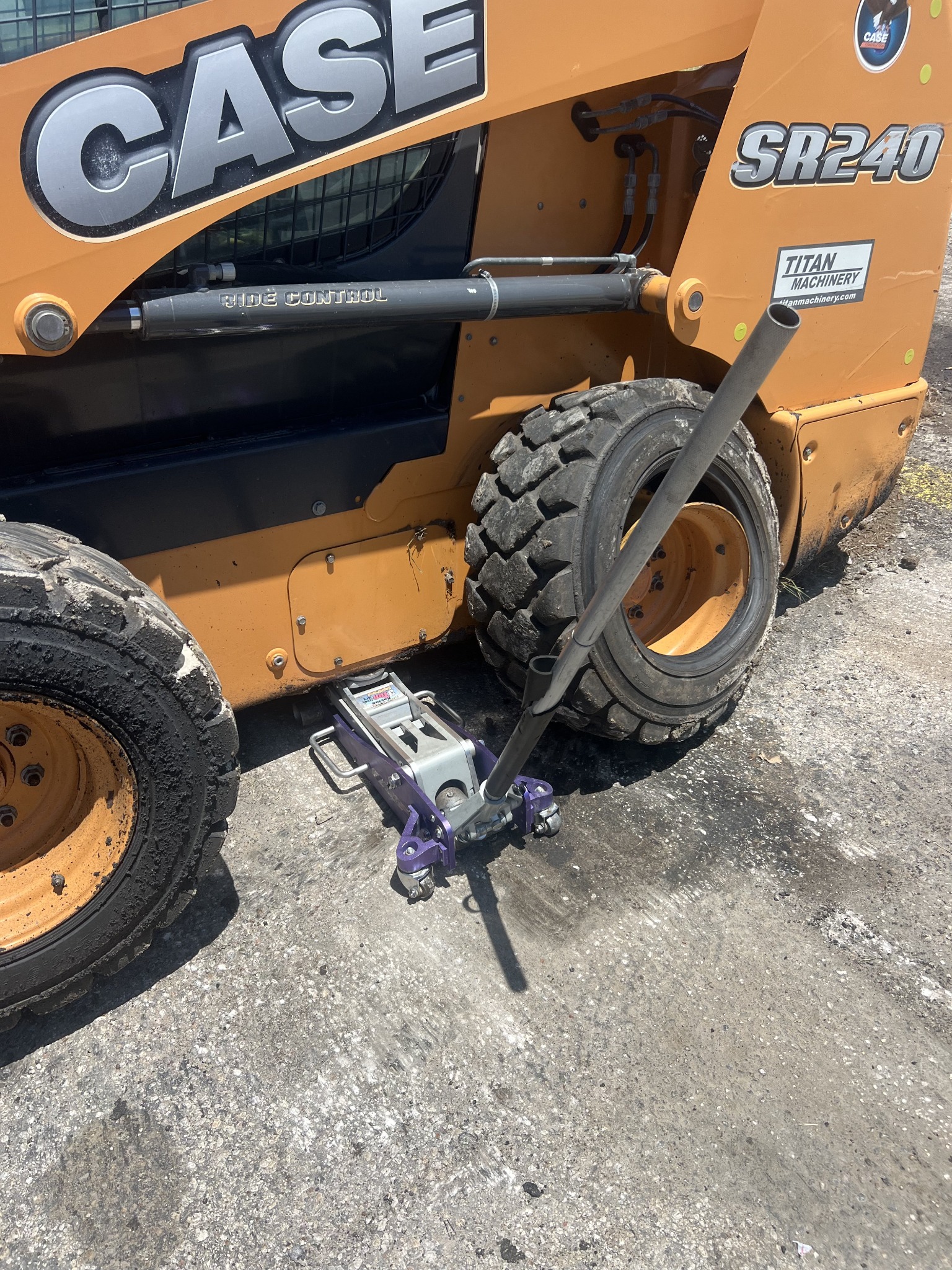 CASE skid steer raised on a jack for tire service